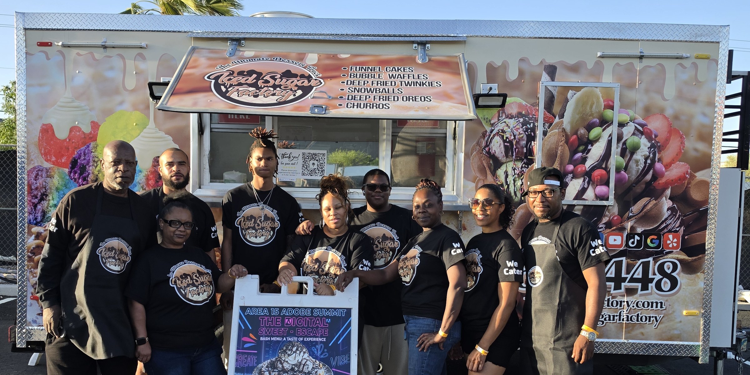Iced Sugar Factory family team standing together in branded shirts in front of the dessert truck